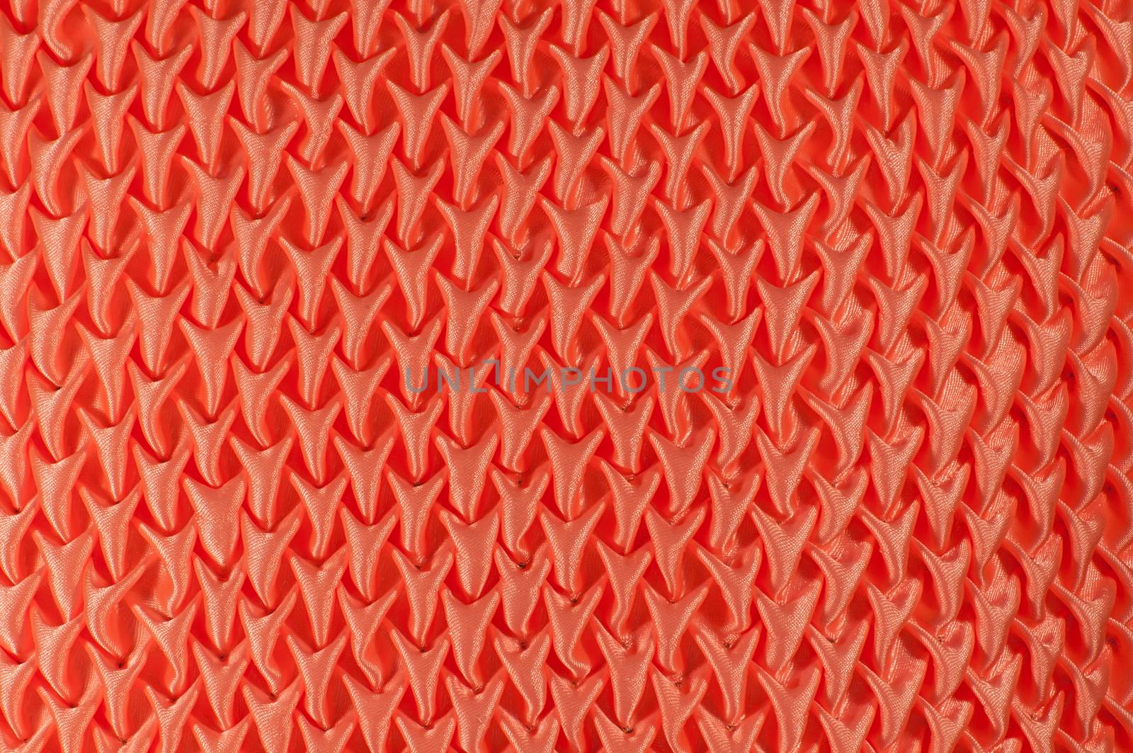 Pattern embroidered orange pillow and texture background
