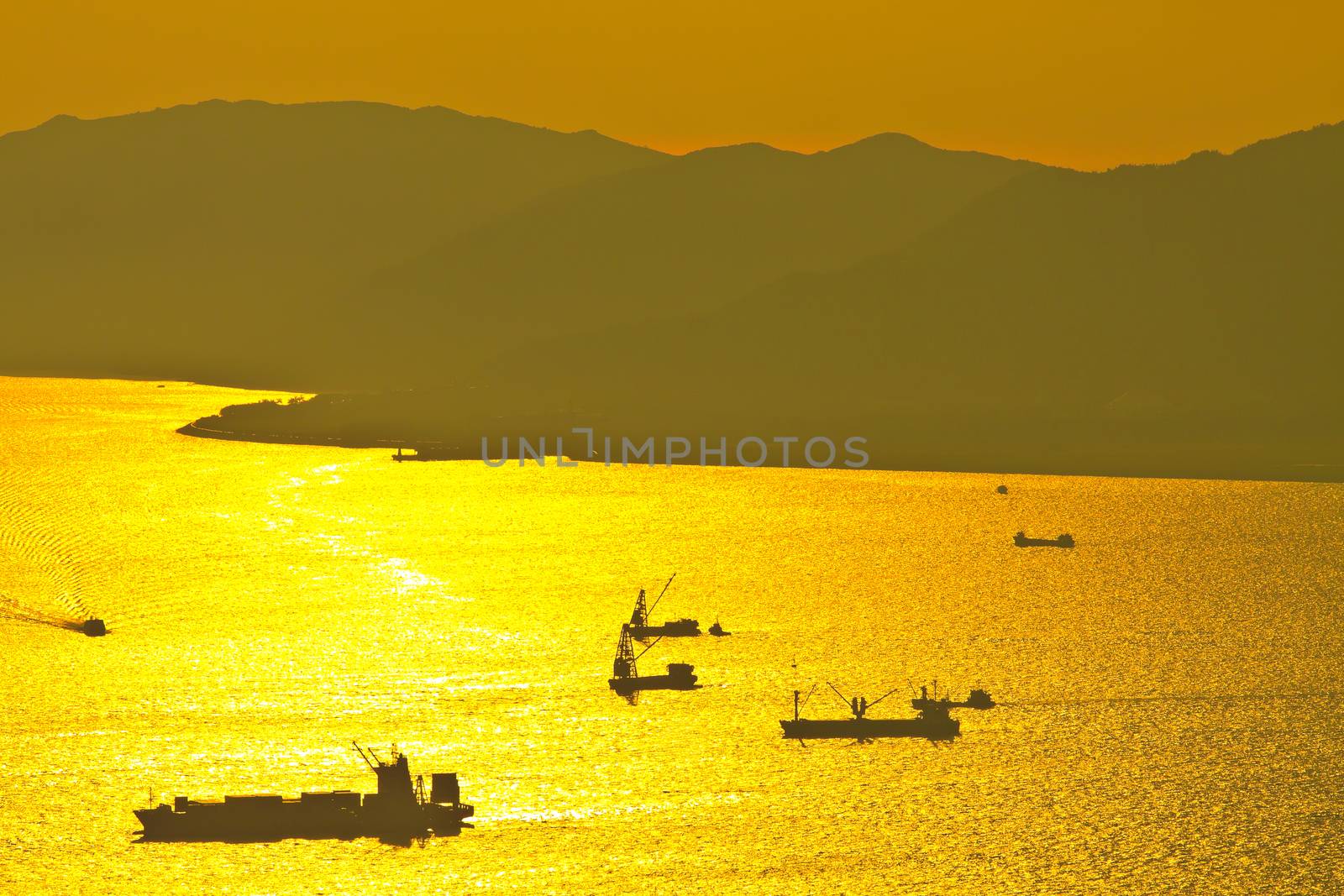 Bulk-carrier ship at sunset in the sea