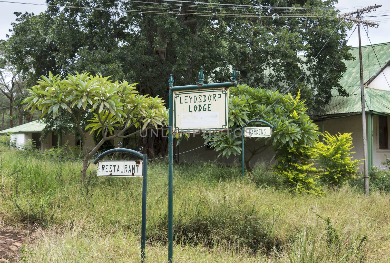old abandon gold mine village leydsdorp in south arica with parking and restaurant sign