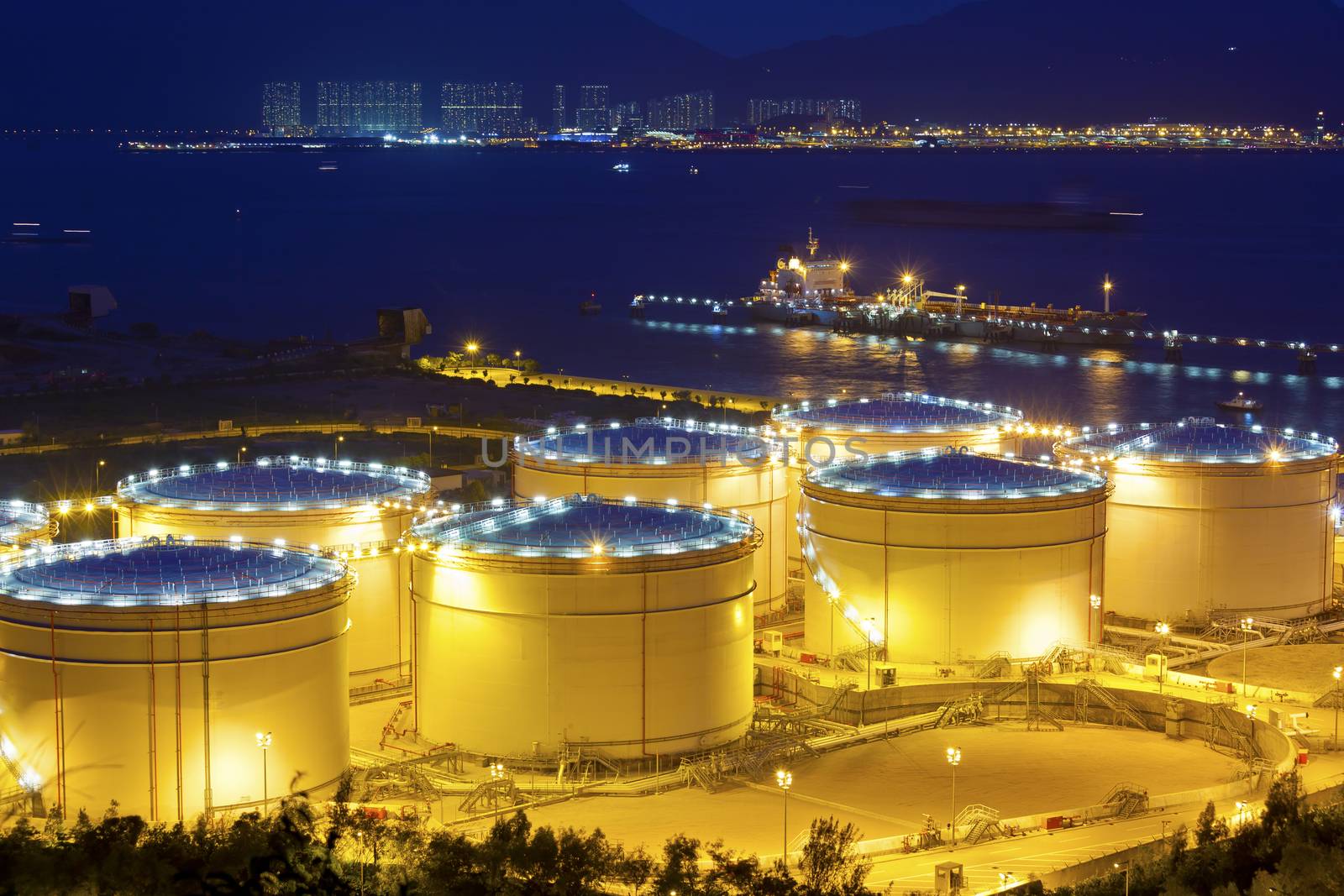 Big Industrial oil tanks in a refinery at night