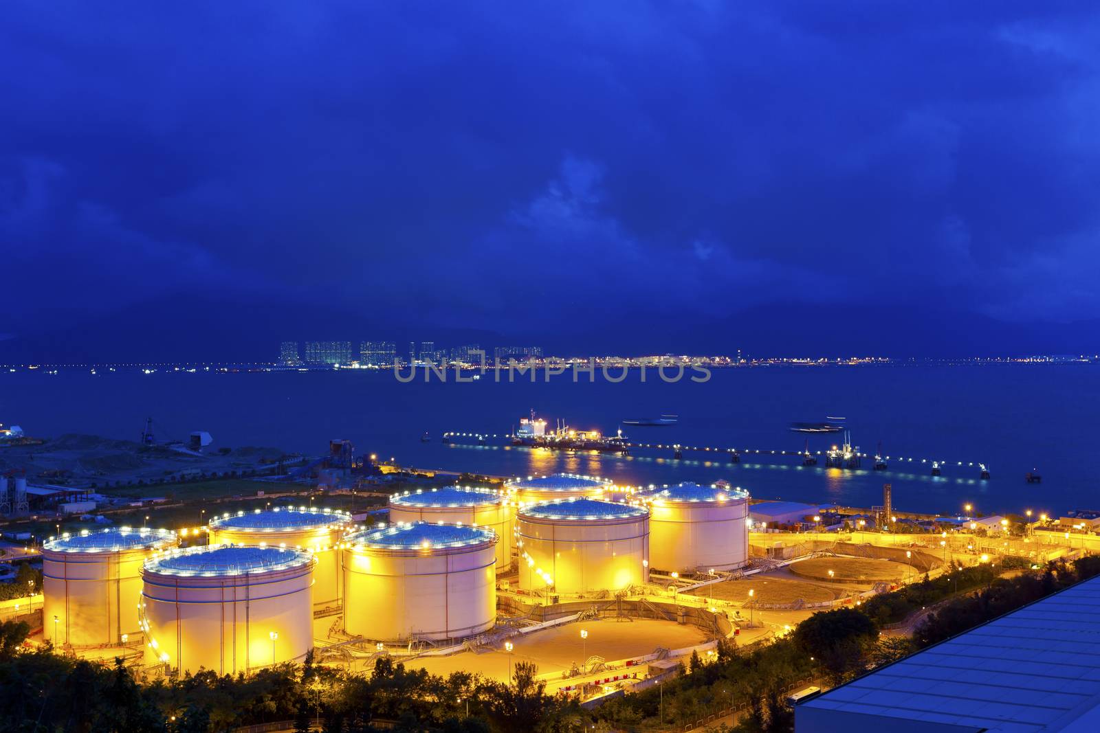 Big Industrial oil tanks in a refinery at night