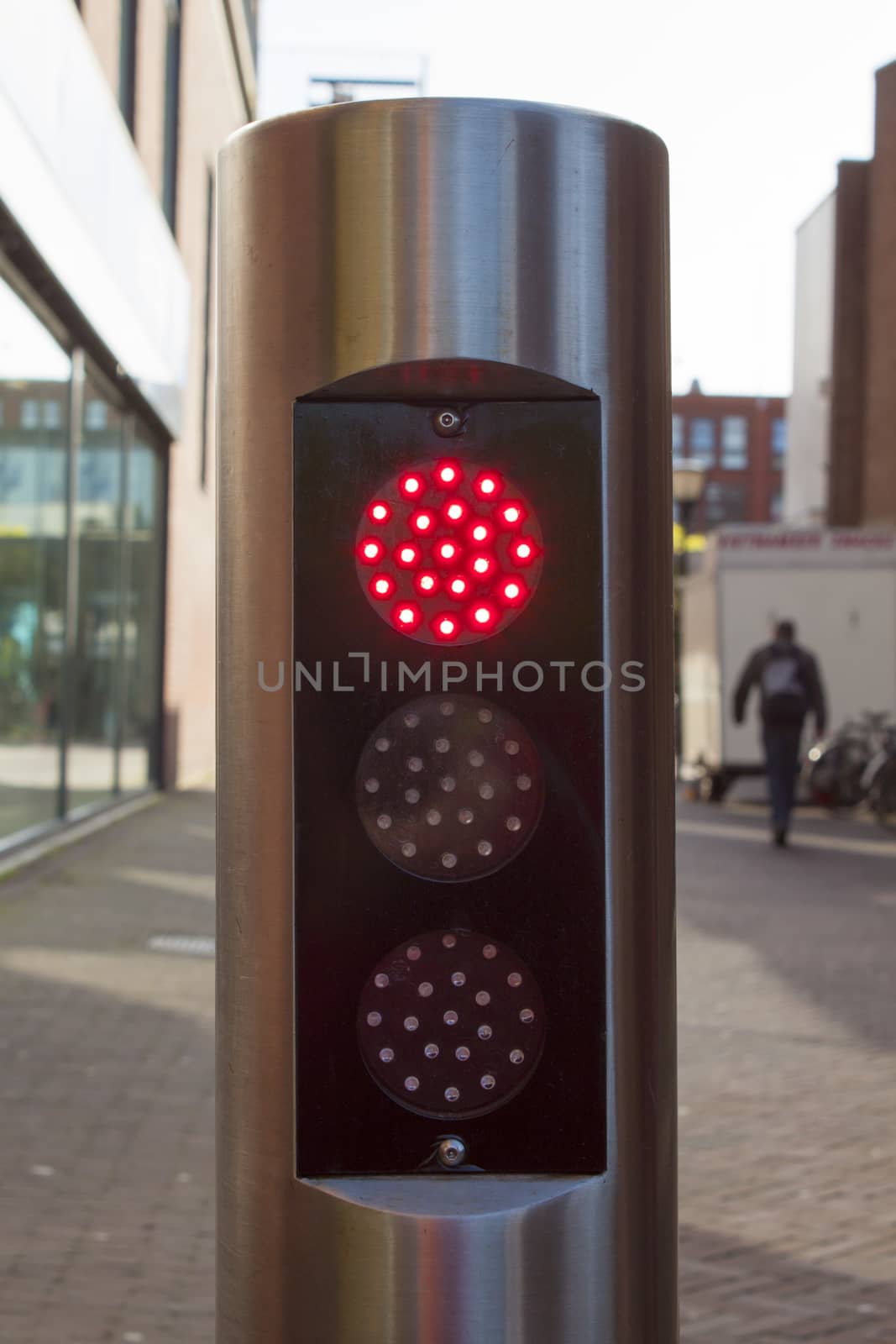 red traffic light on silver tube with black background