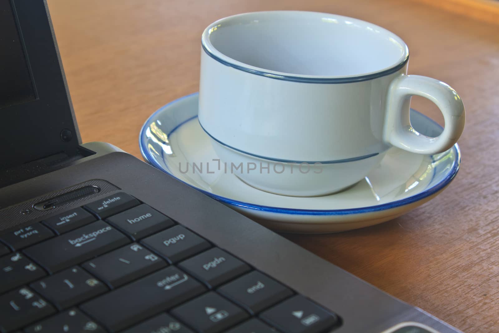 Coffee cup and laptop for business on table