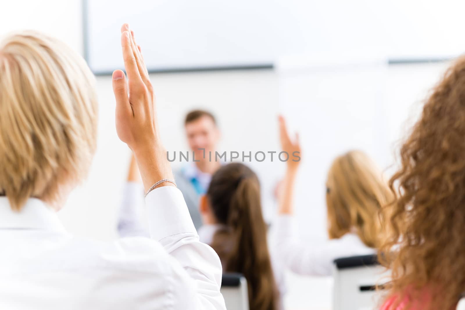 image of a male hand raised in university classroom