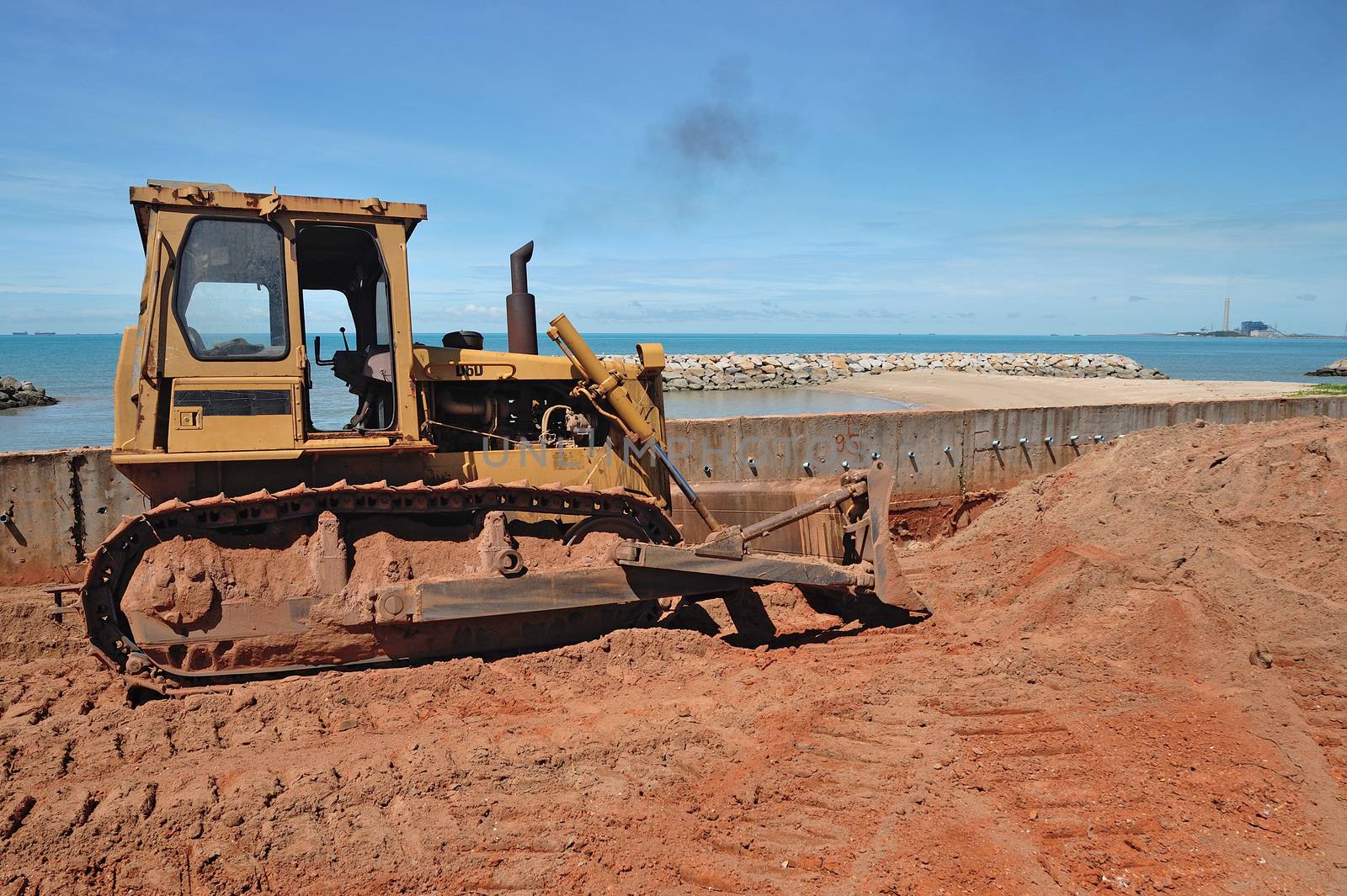 repairing road and sea breaker in beach near ocean by think4photop