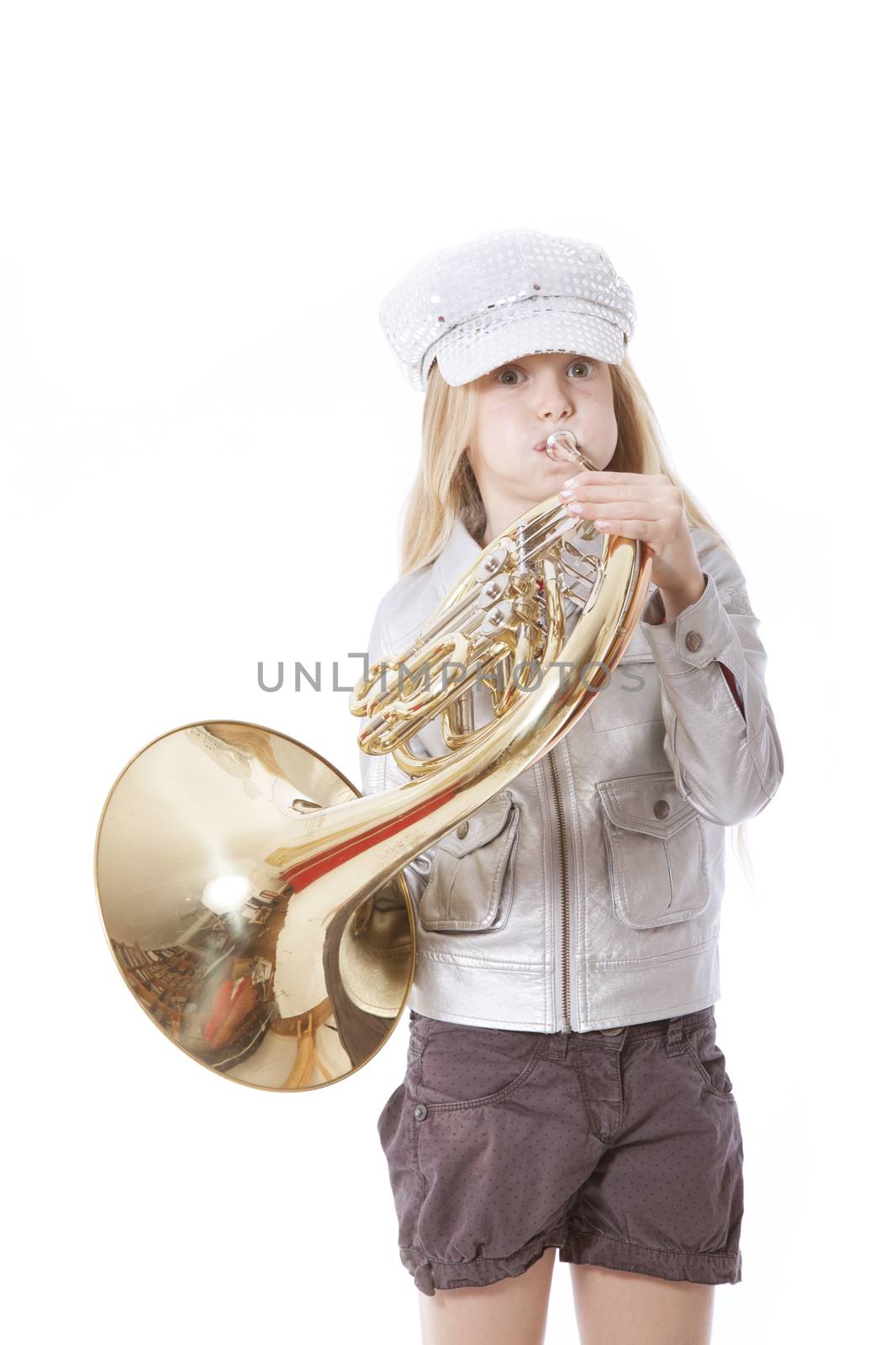 young girl with cap playing french horn against white background