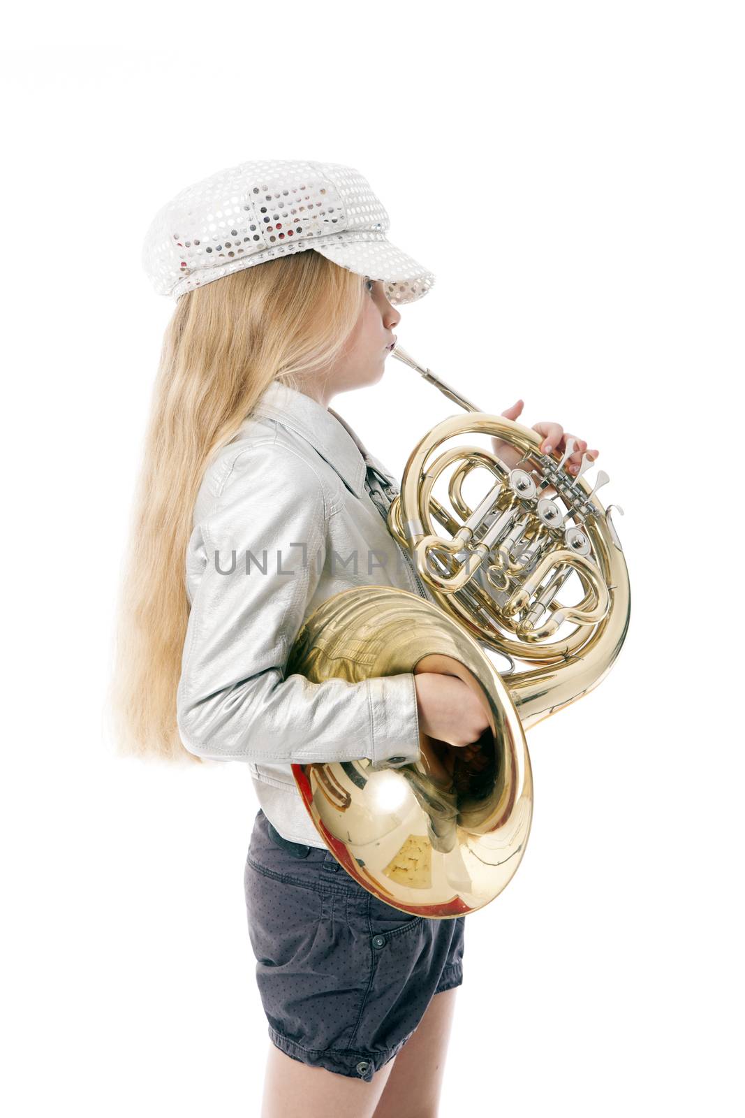 young girl with cap playing french horn against white background