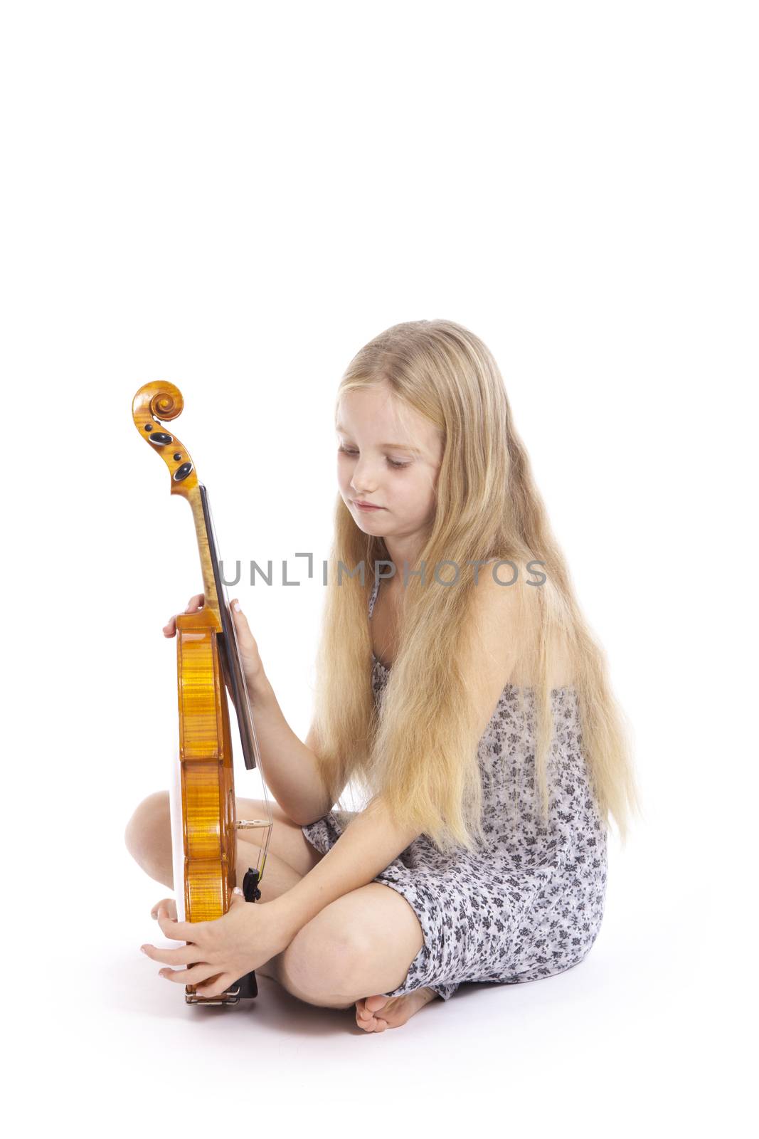 young girl in dress and her violin in studio against white background