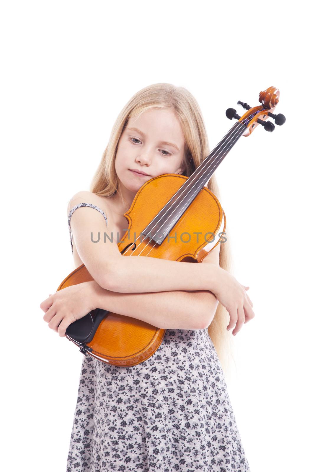 young girl in dress embracing violin in studio