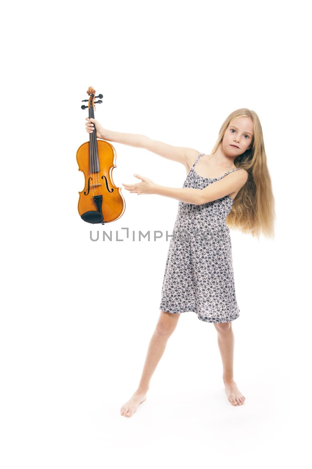 young girl in dress showing her violin in studio