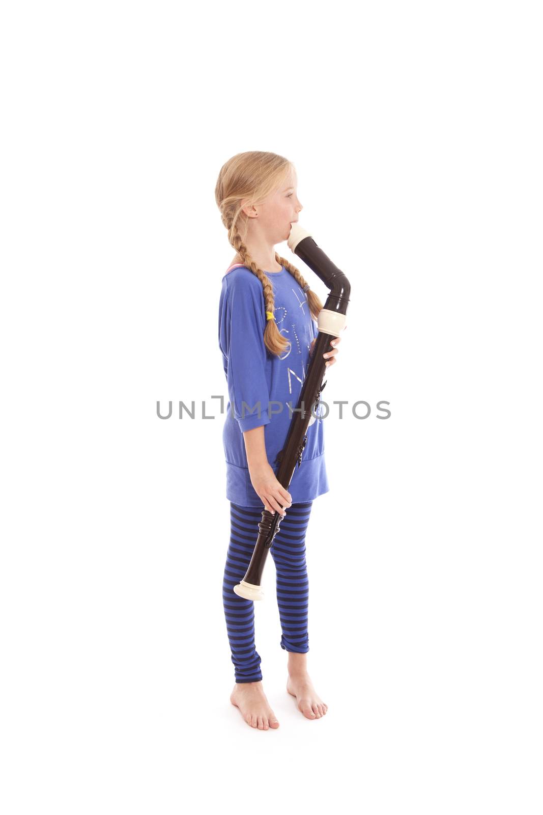young girl in blue playing bass recorder against white backgound