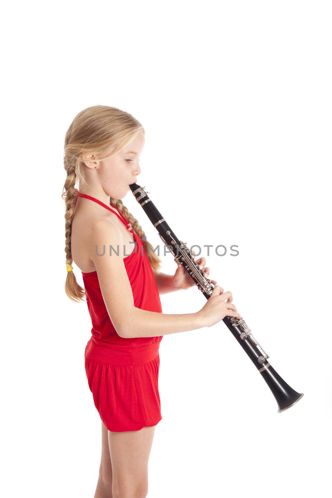 young girl in red playing clarinet by ahavelaar