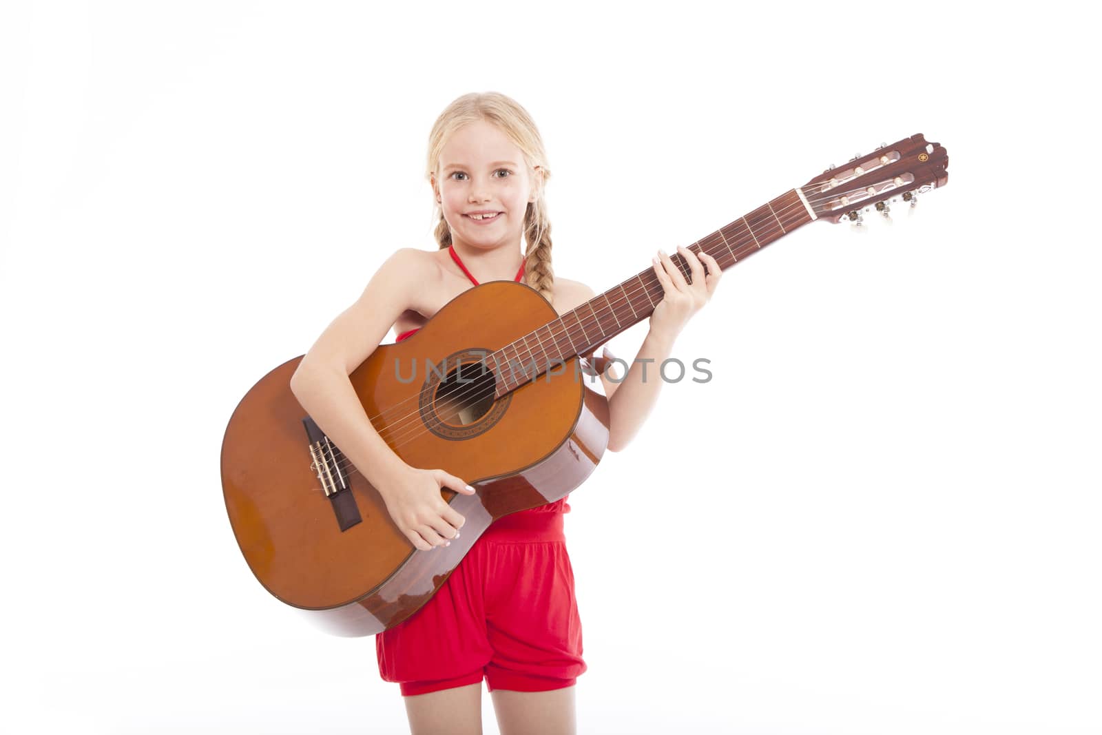 young happy girl standing with guitar against white background