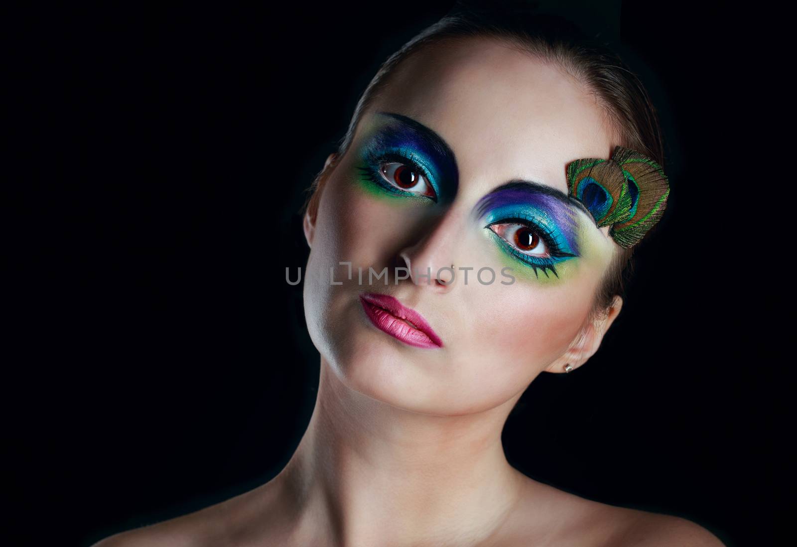 Attractive young girl with makeup peacock bird closeup portrait