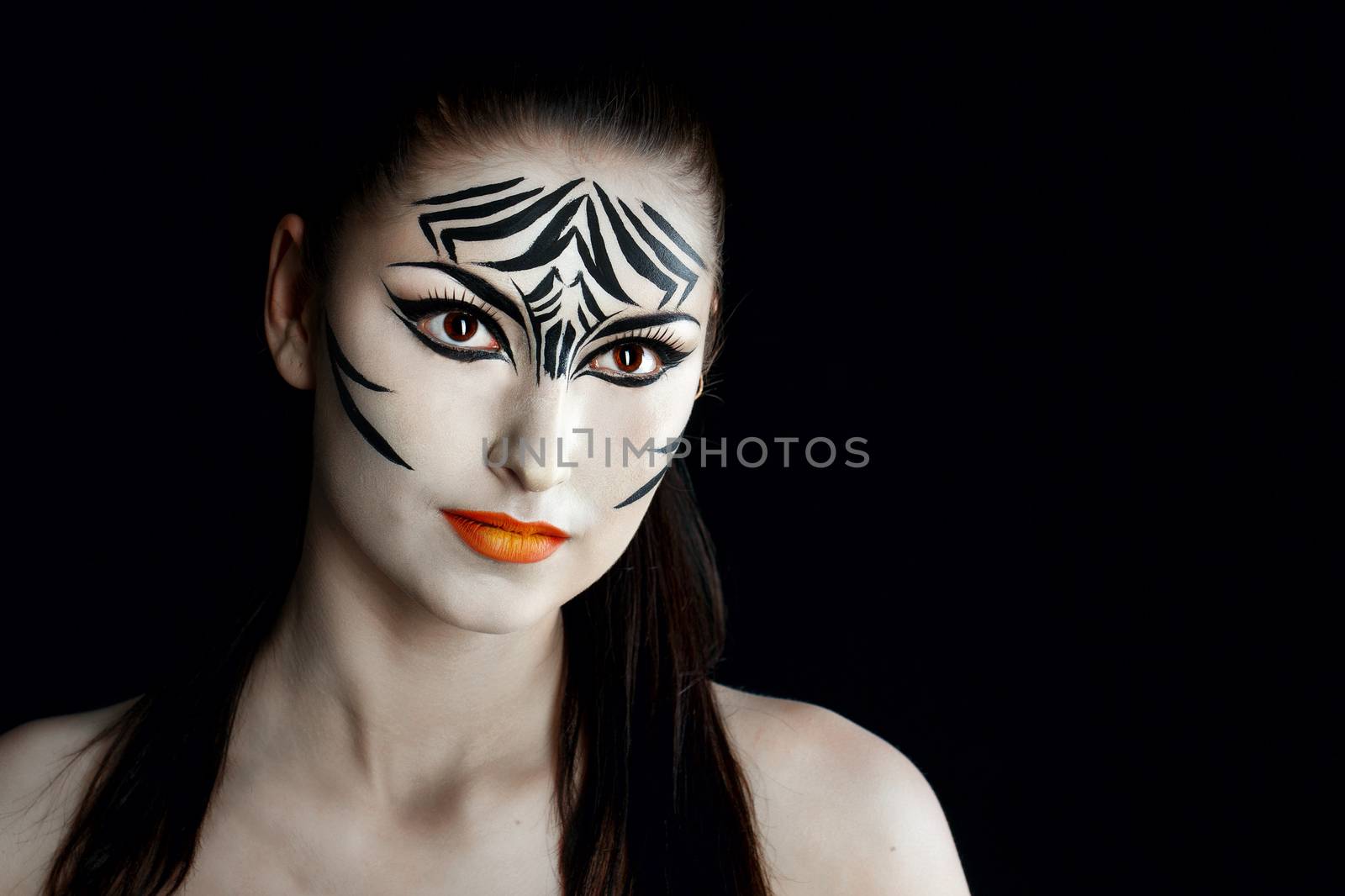 Attractive young girl with make-up of wild zebra close-up portrait