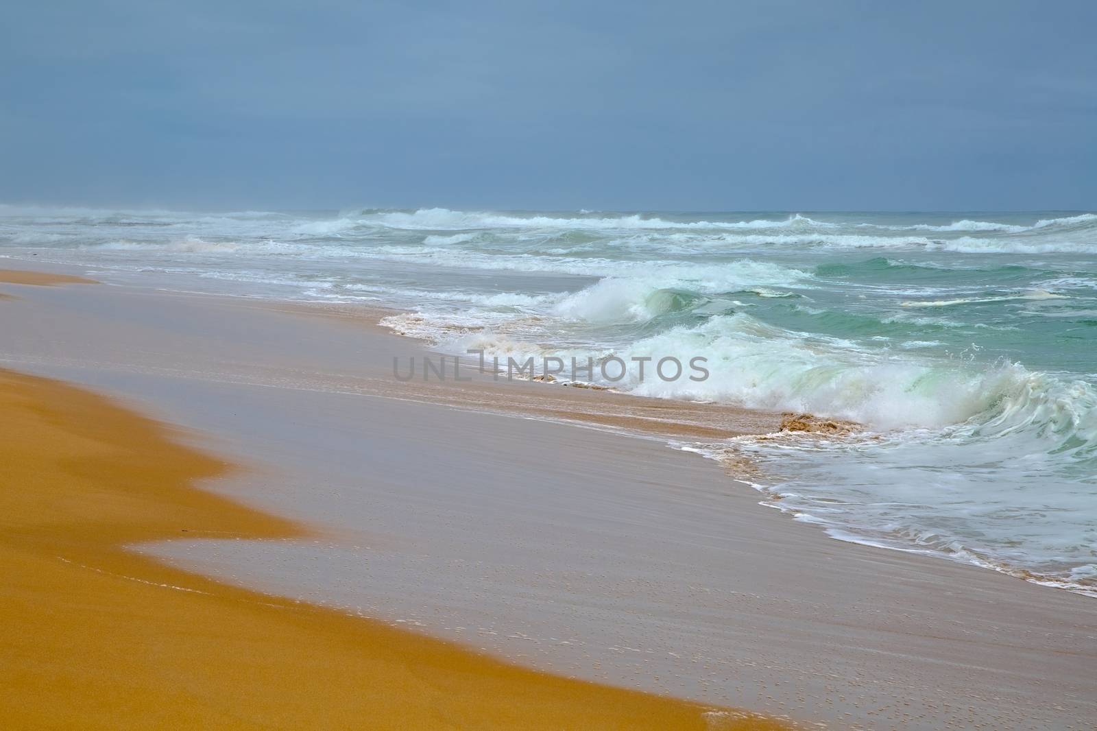 Sandy beach with big waves