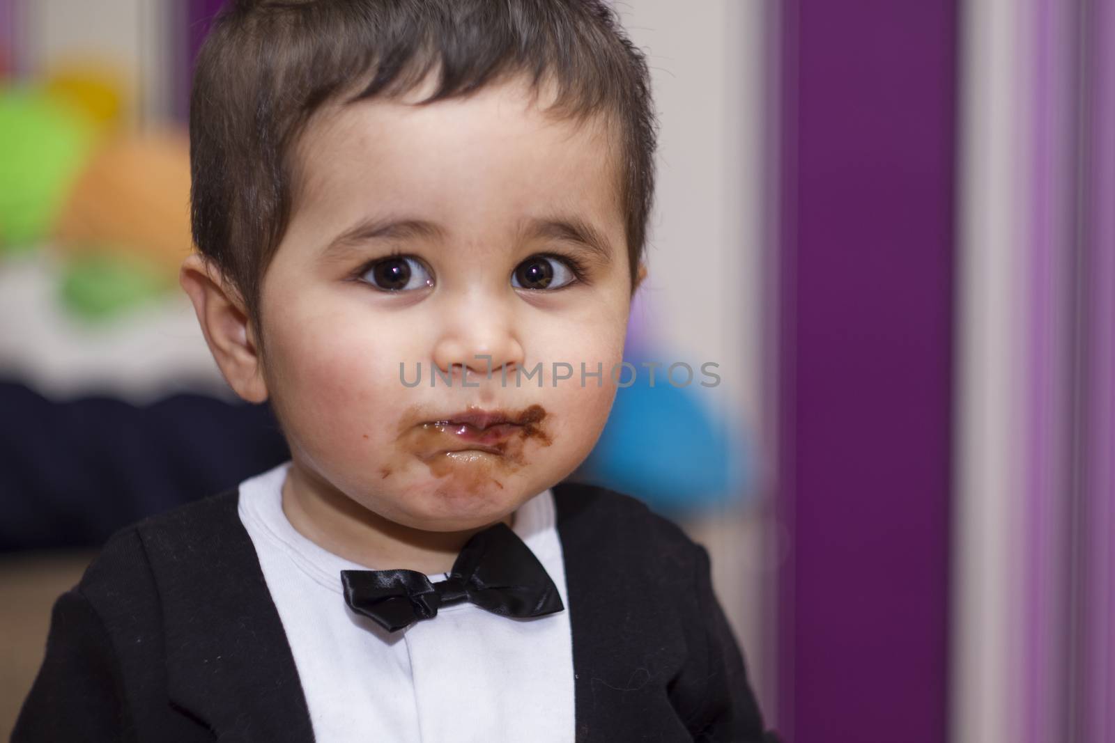 Happy, Adorable happy baby eating chocolate, wearing suit and bo by FernandoCortes