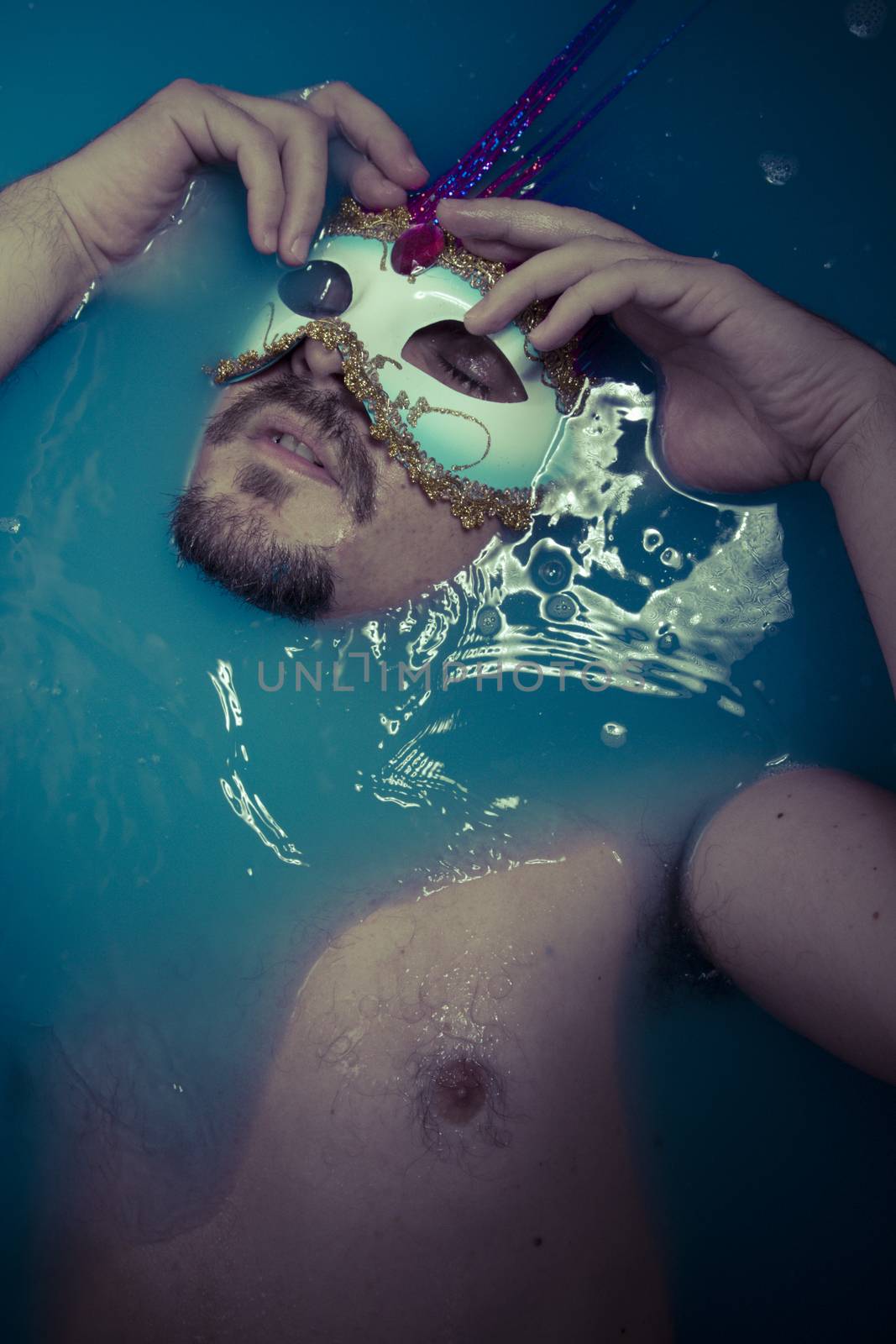 Depression, man in blue tub full of water, sadness concept by FernandoCortes