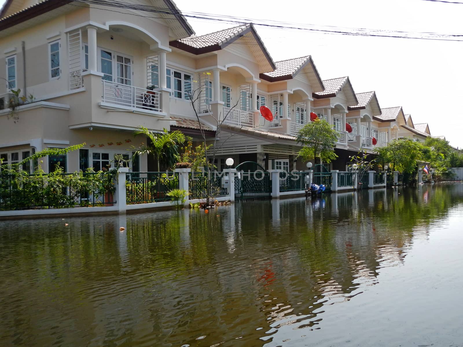 flood waters overtake a house in Thailand by think4photop