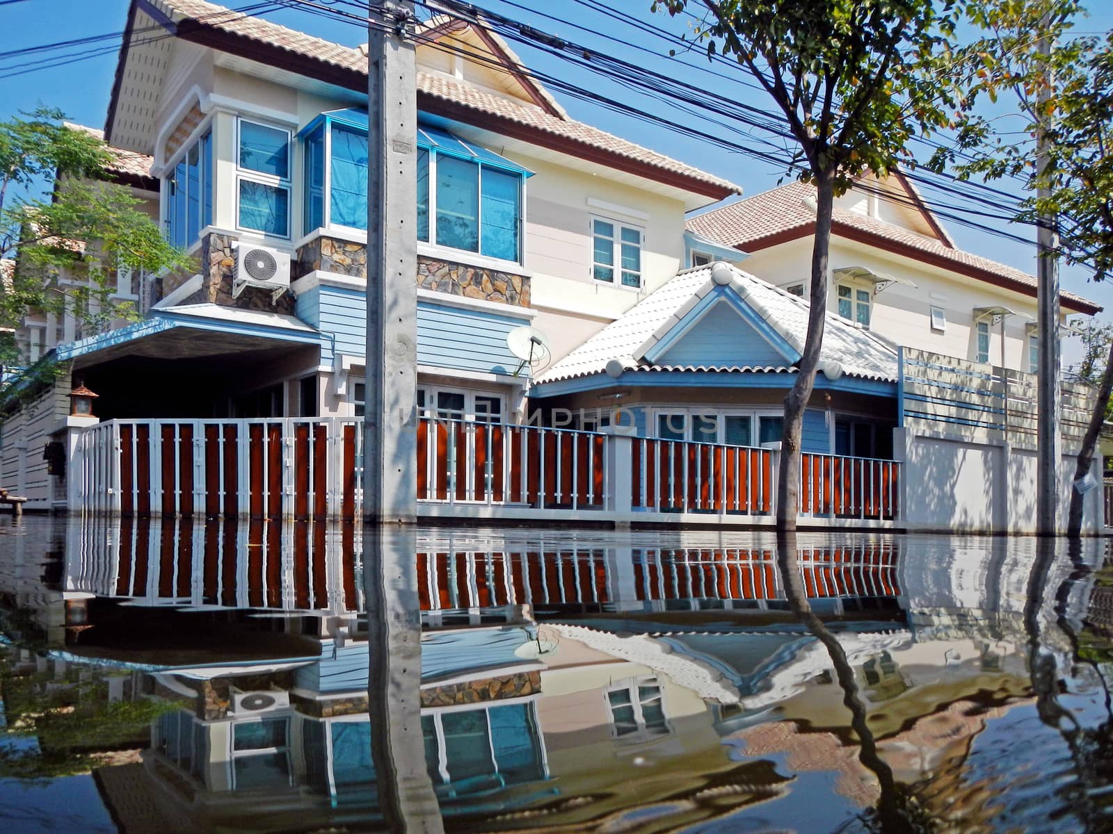 flood waters overtake a house in Thailand by think4photop