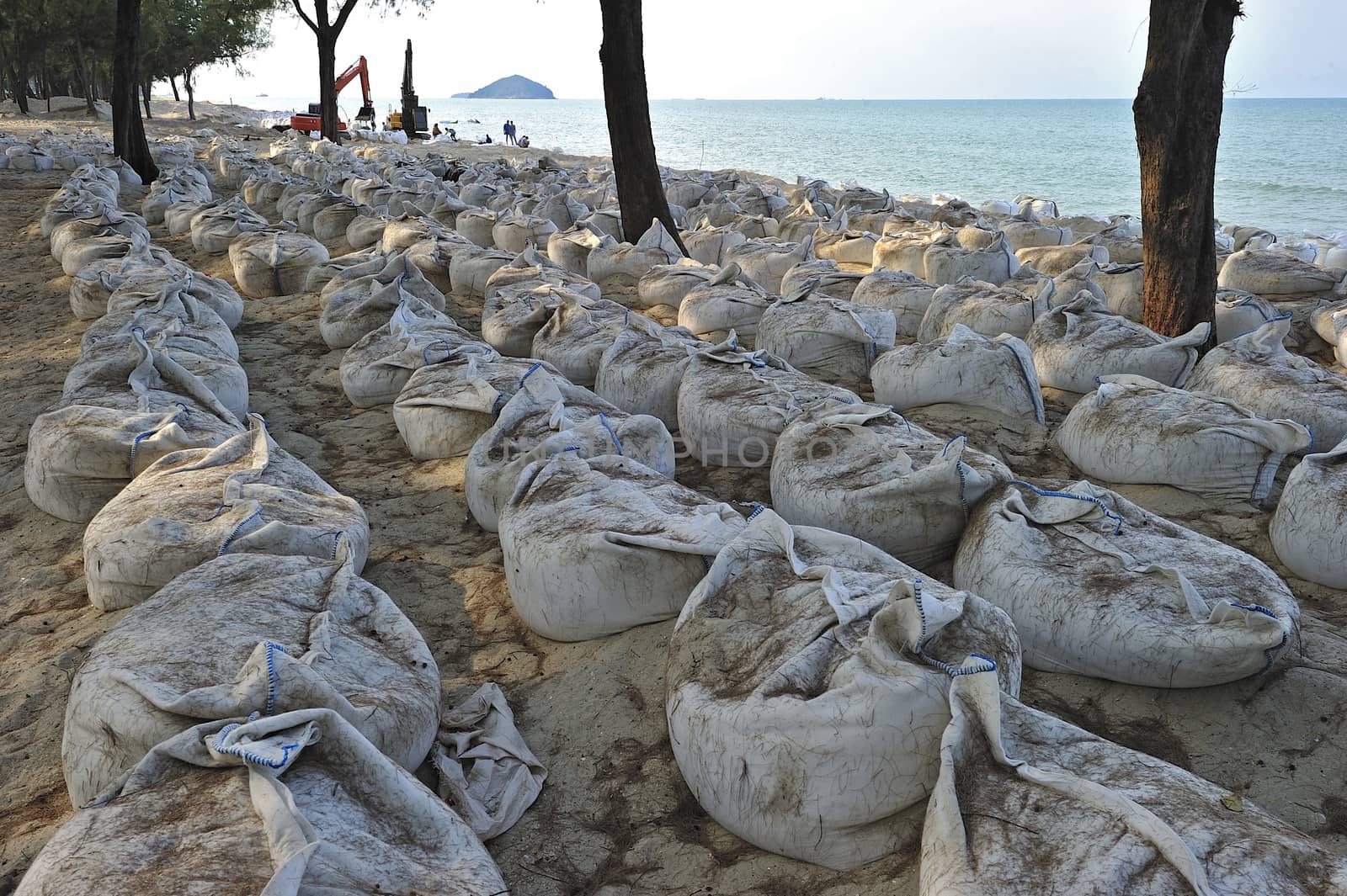 Sand bags along the beach in Songkra to protect from heavy surf by think4photop