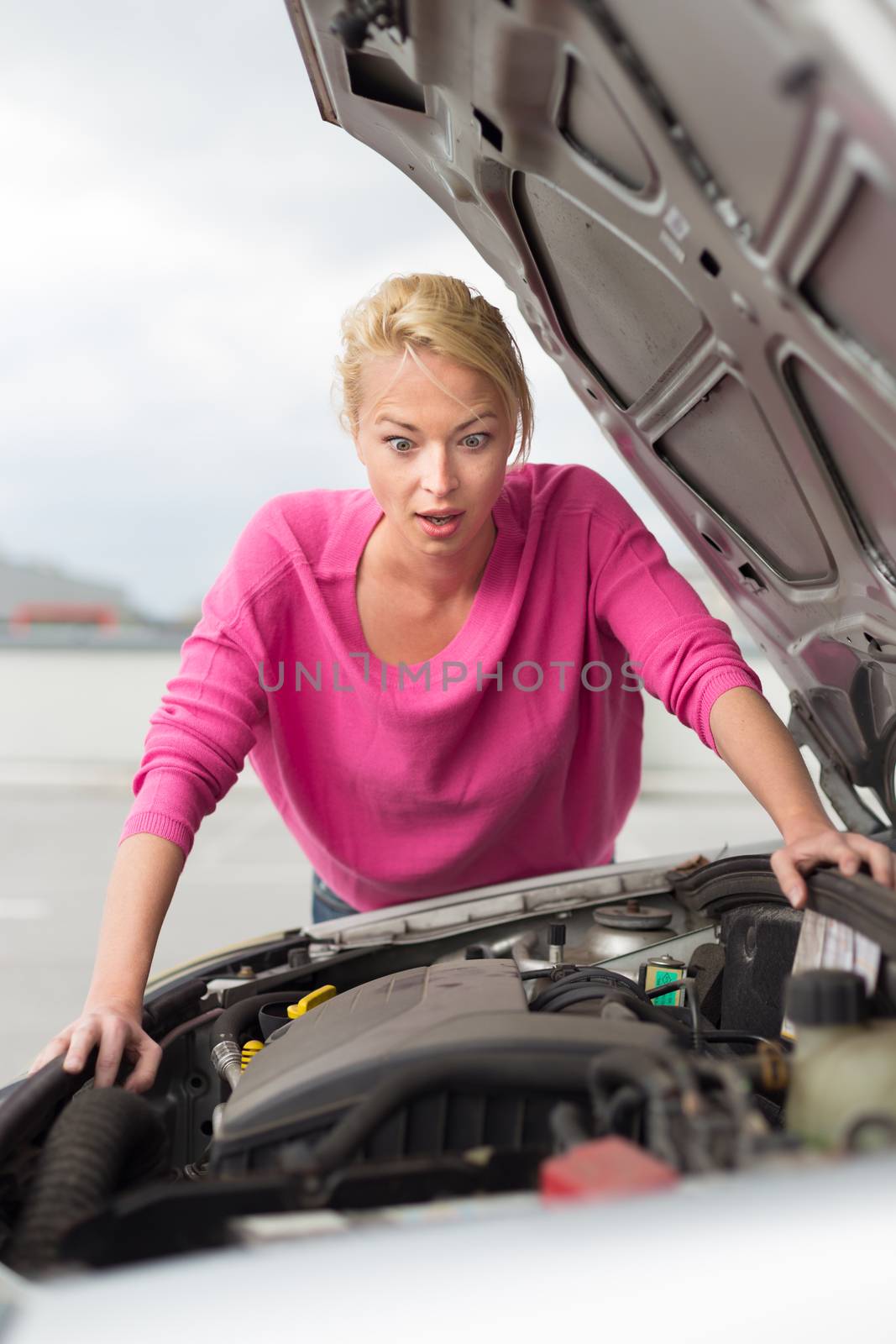 Stressed Young Woman with Car Defect. by kasto