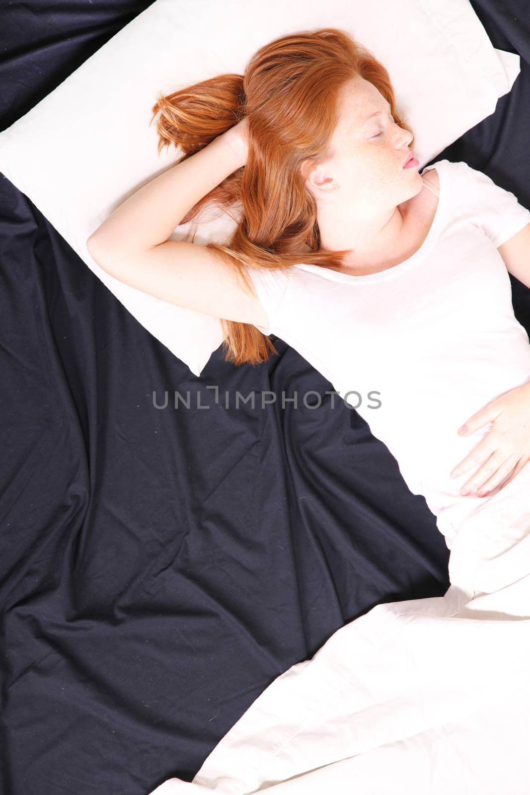 A young adult Woman sleeping on bed.
