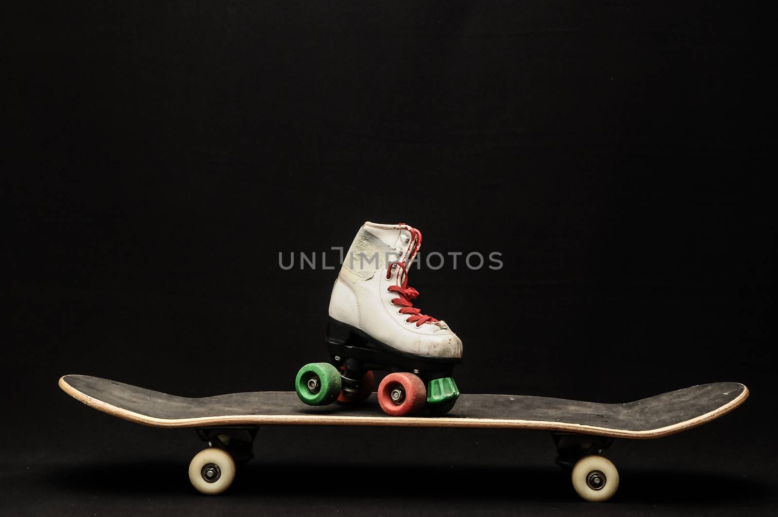 Vintage Style Black Skateboard and Skate Boot on a Dark Background