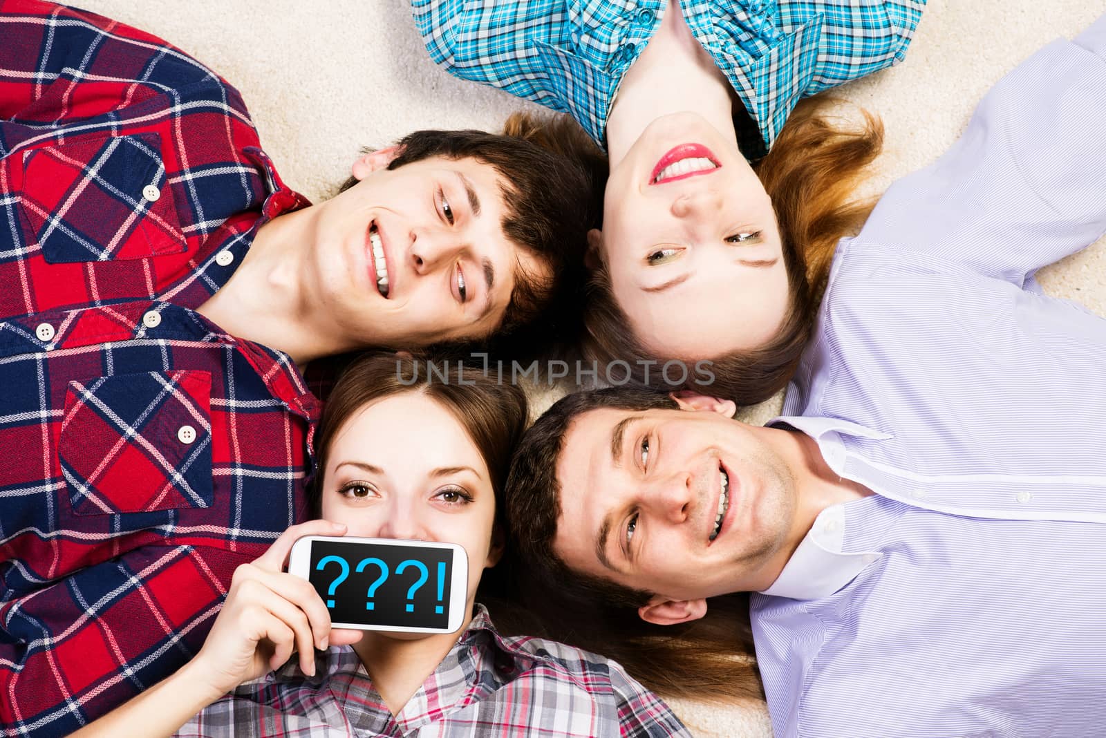 four young men lie together, young attractive woman pressed her lips to the phone