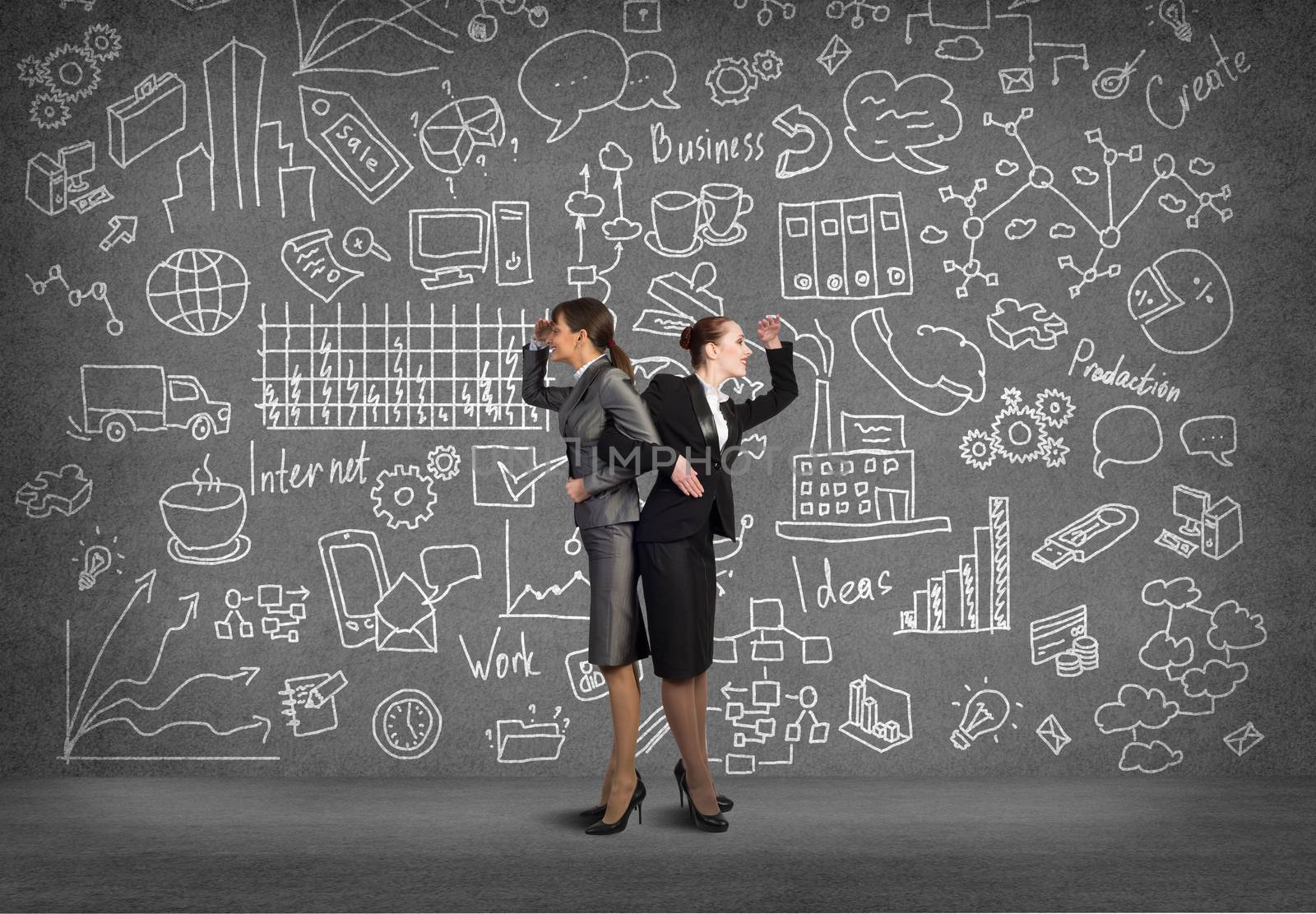 two business women holding hands, looking in different directions, teamwork