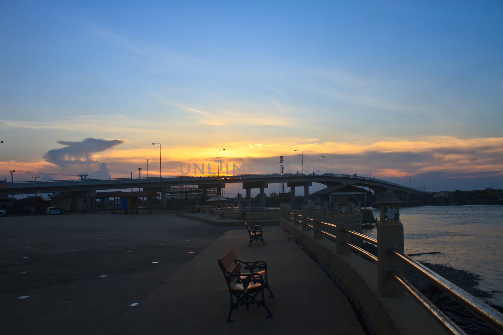 Colorful sunset and Bridge over river in Thailand 