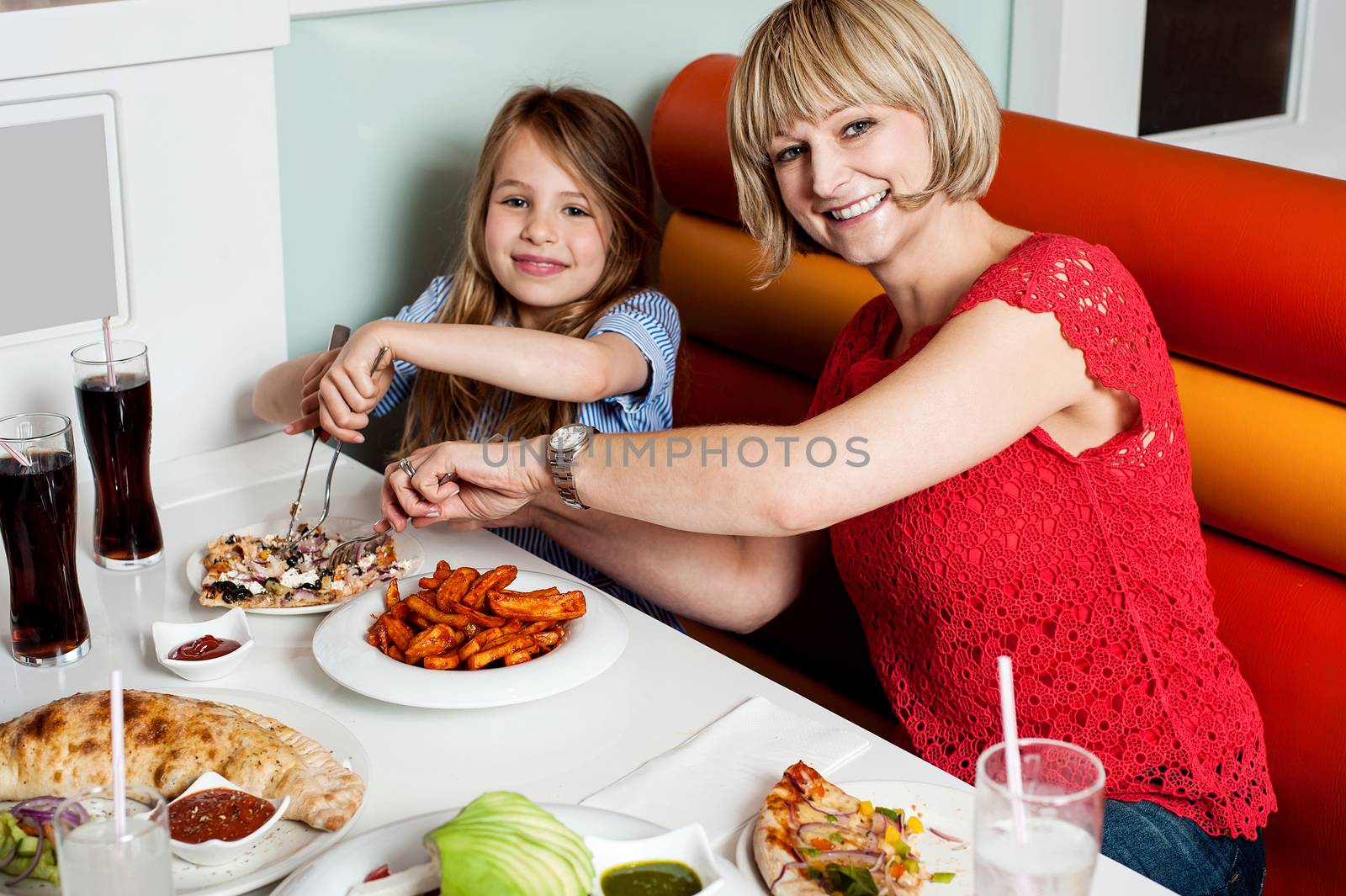 Mother and daughter in a restaurant by stockyimages