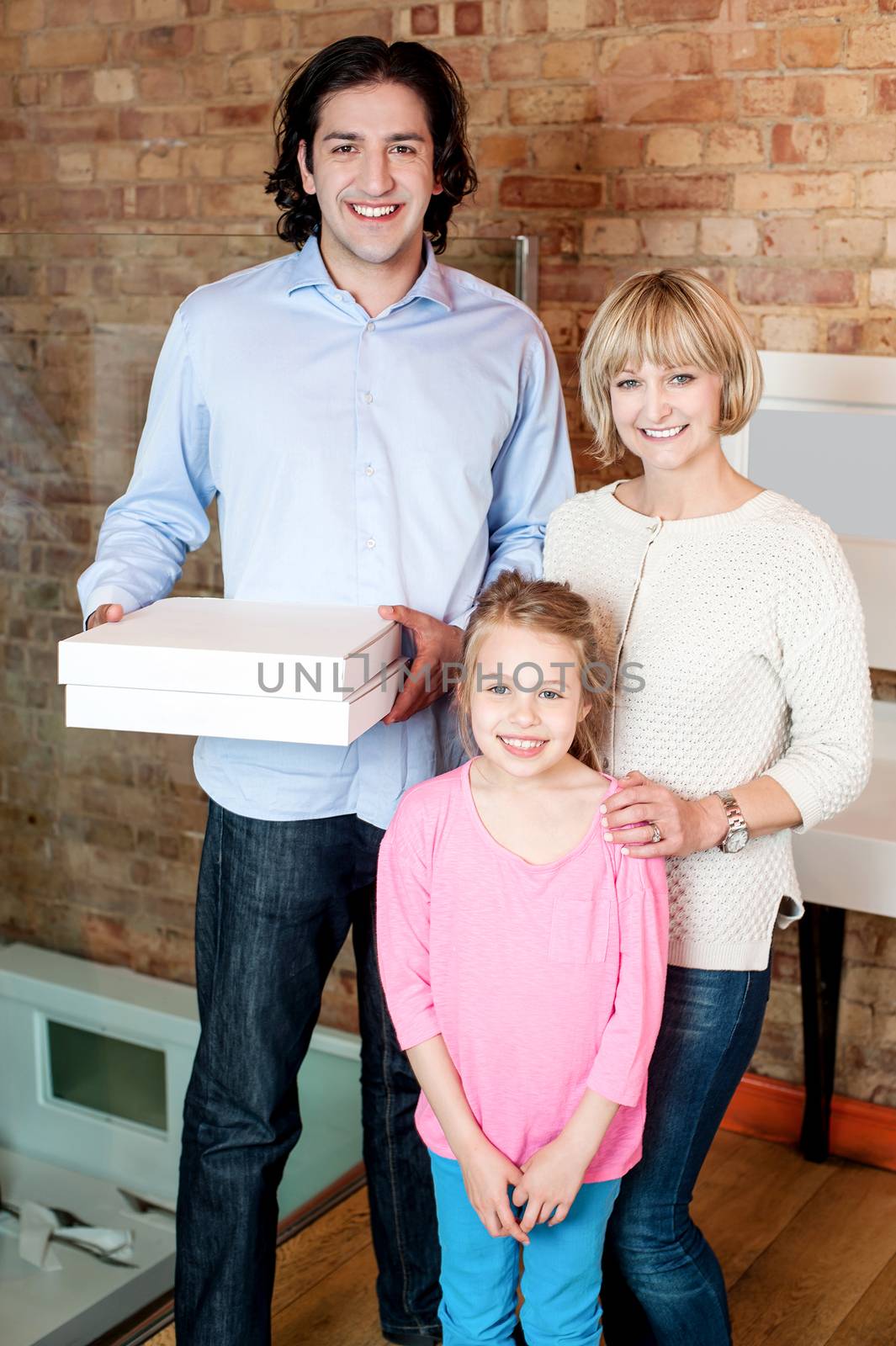 Young man with his family holding pizza boxes