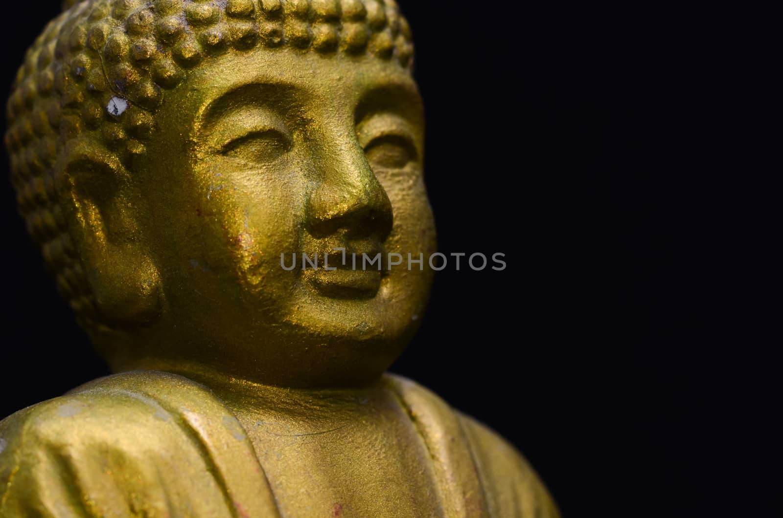 Golden Buddha Statue on a Black Background