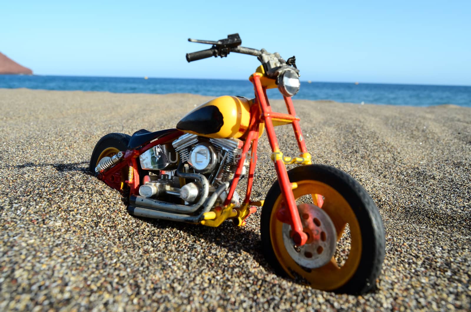 Transportation Concept Toy Motorcycle on the Sand Beach