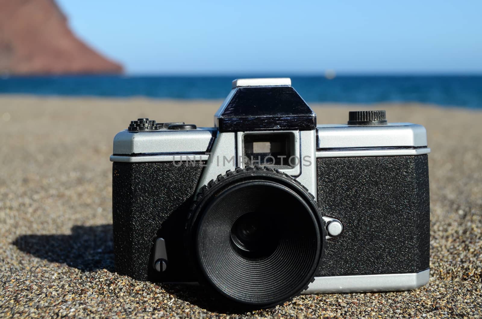 Old Photo Camera on the Sand Beach