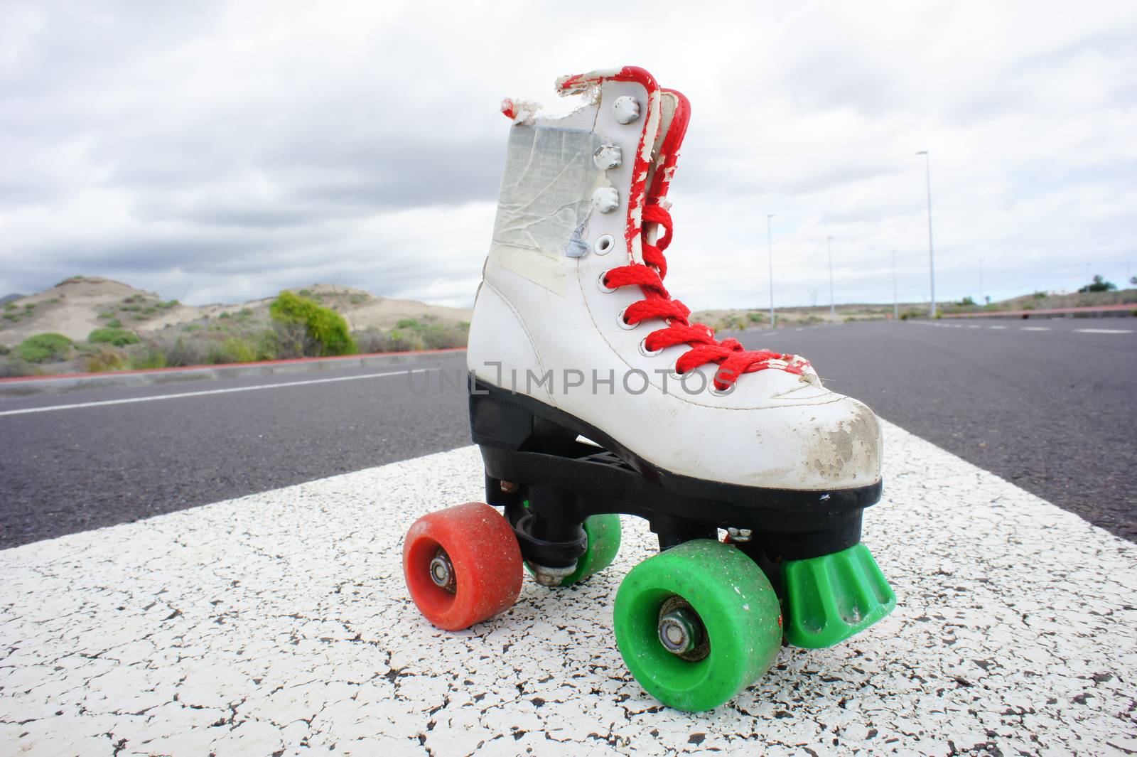 Old Vintage White Skate Boot on the Asphalt Sterret