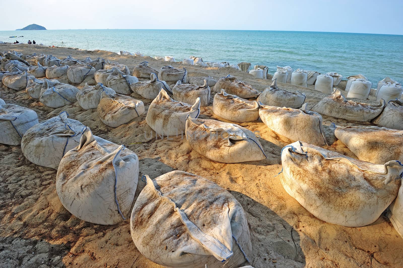 Sand bags along the beach in South of Thailand to protect from h by think4photop