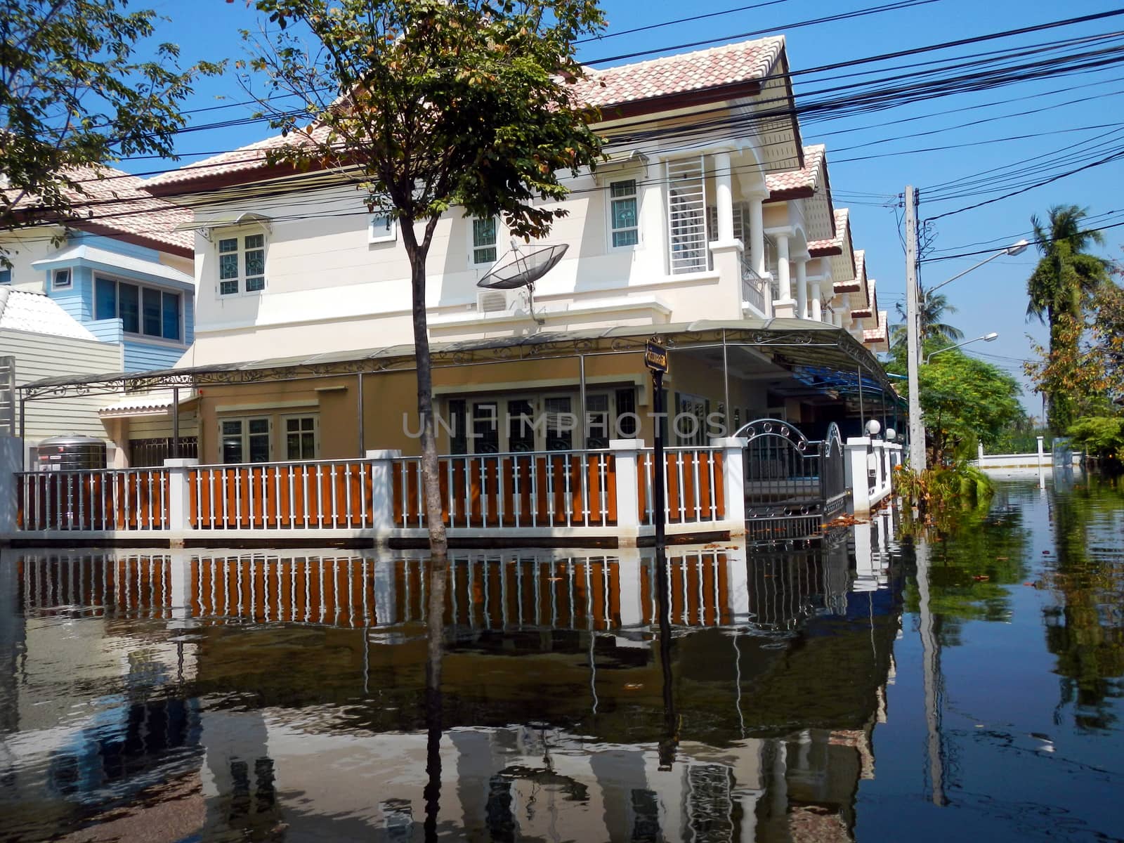 flood waters overtake a house in Thailand by think4photop