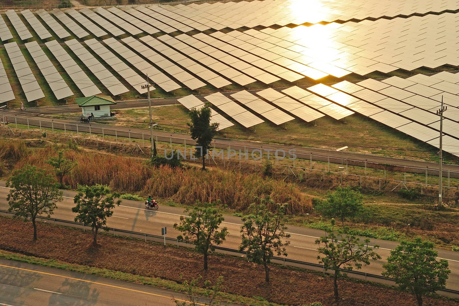 Aerial photo of solar power plant reflected sunlight from sunset.