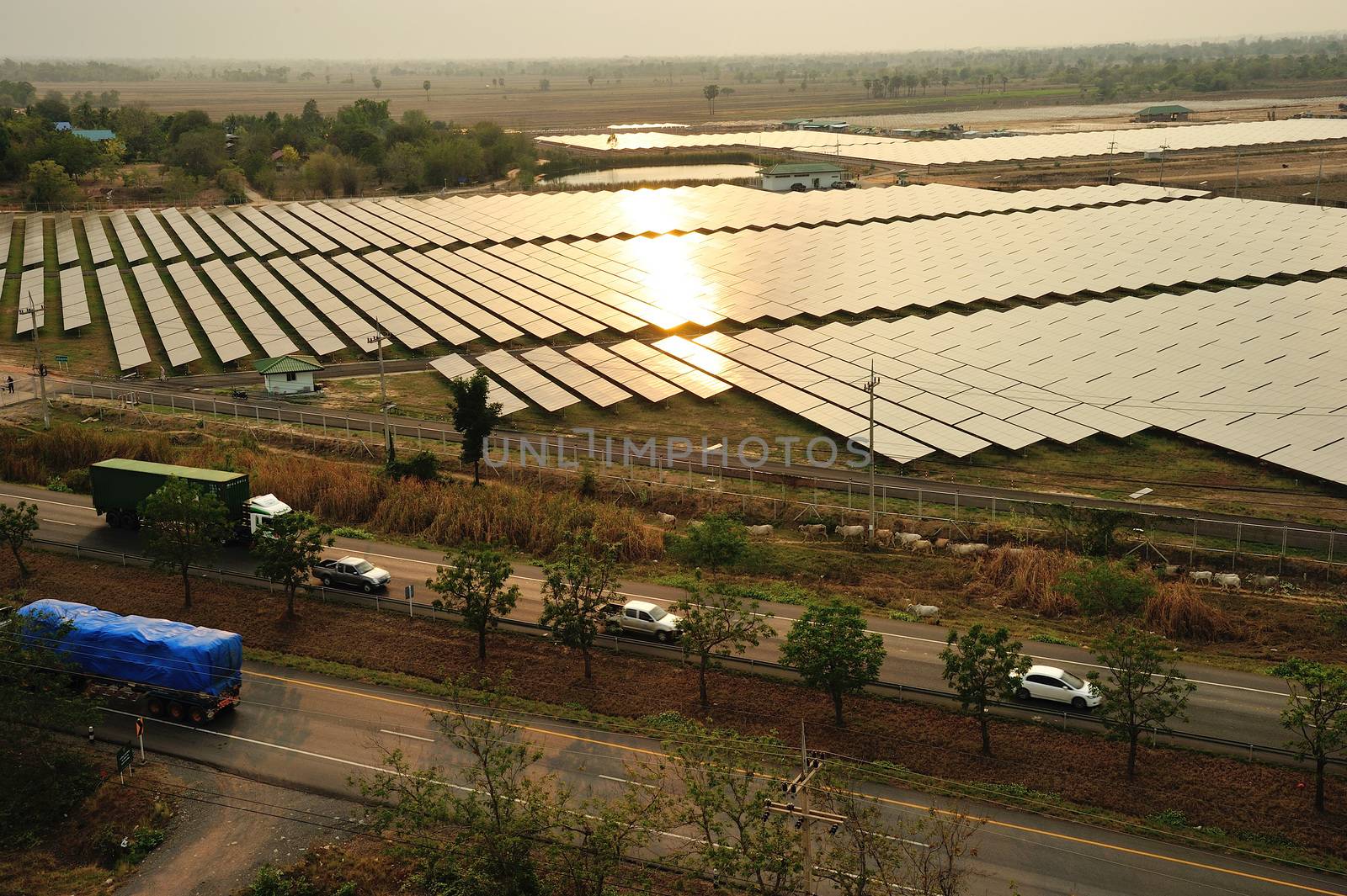 Aerial photo of solar power plant reflected sunlight from sunset.