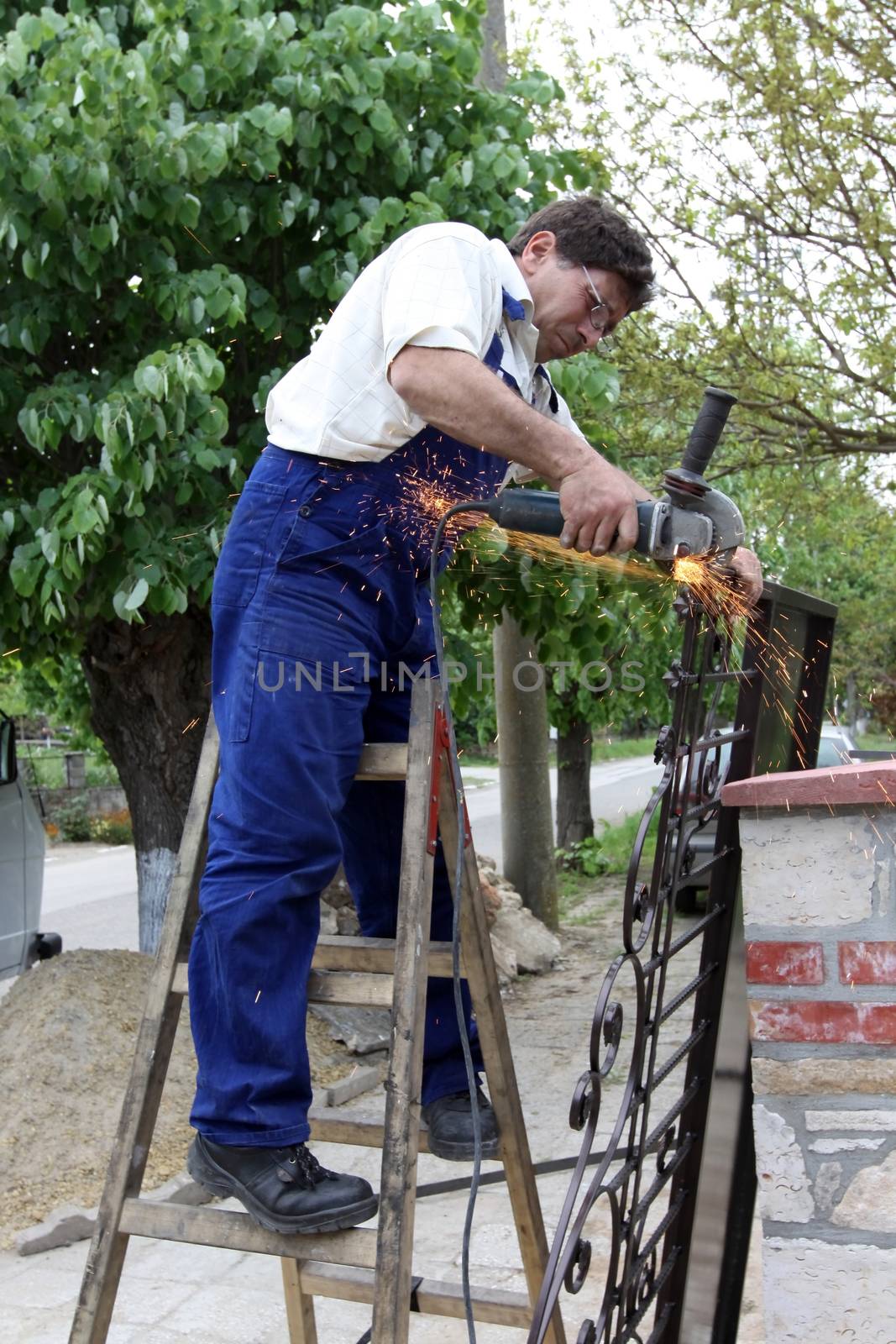a worker working with Angle Grinder