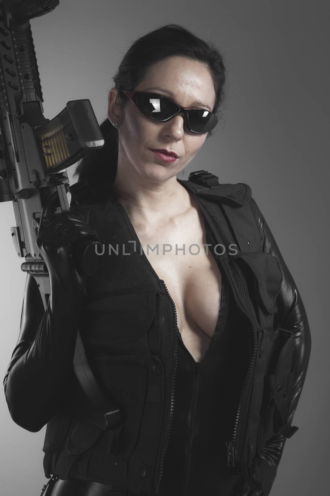 Brunette woman with enormous bulletproof vest and gun by FernandoCortes