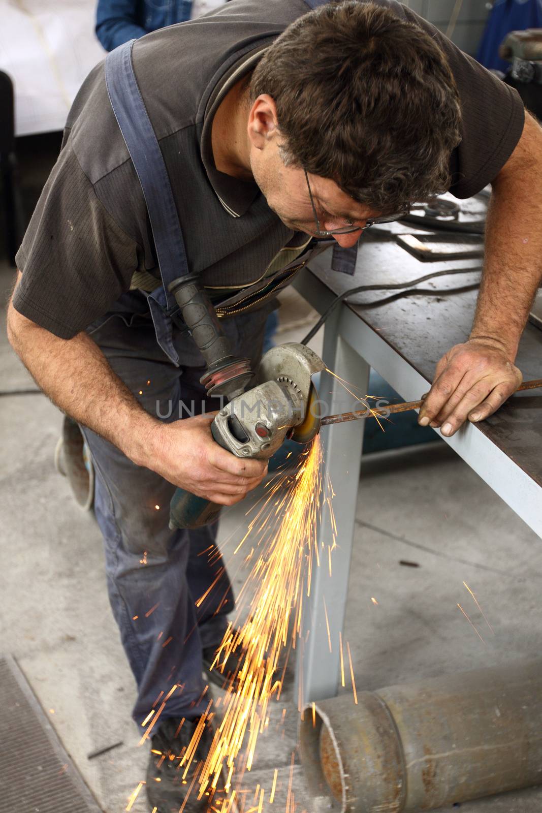 a worker working with Angle Grinder