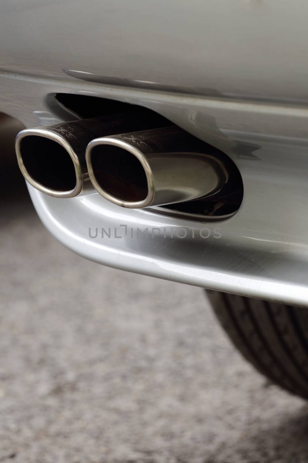 Sportscar twin polished chrome exhaust close up