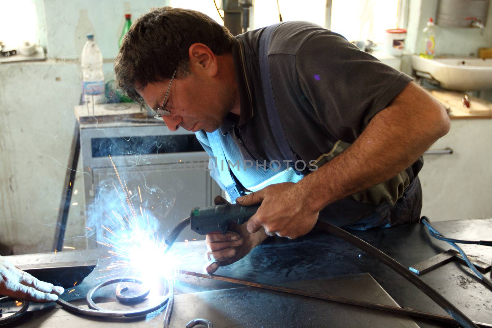 A worker welding metal construction 