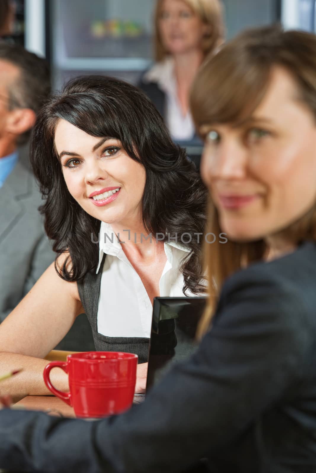 Cheerful young white female with friend in cafe