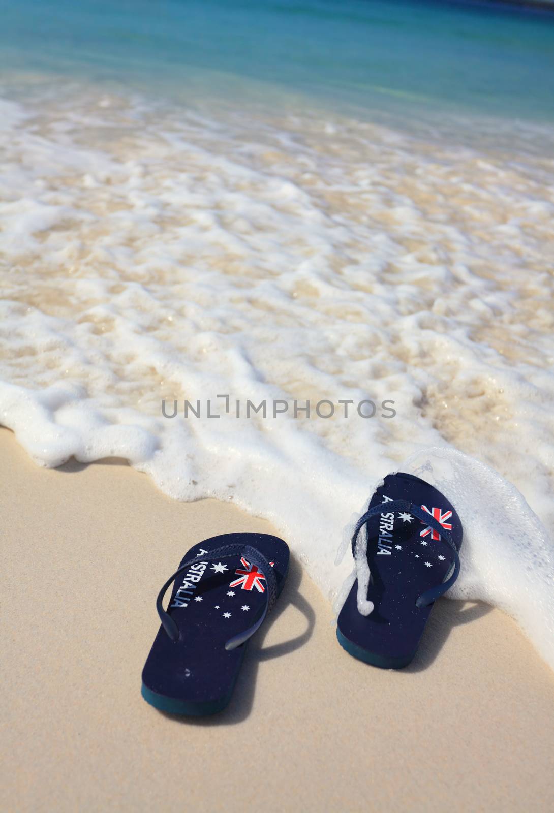 Patriotic Aussie thongs featuring Australian flag on the beach.