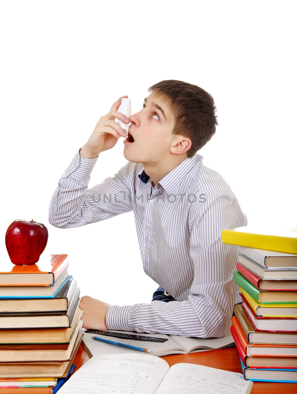 Student with Inhaler at the School Desk on the White Background