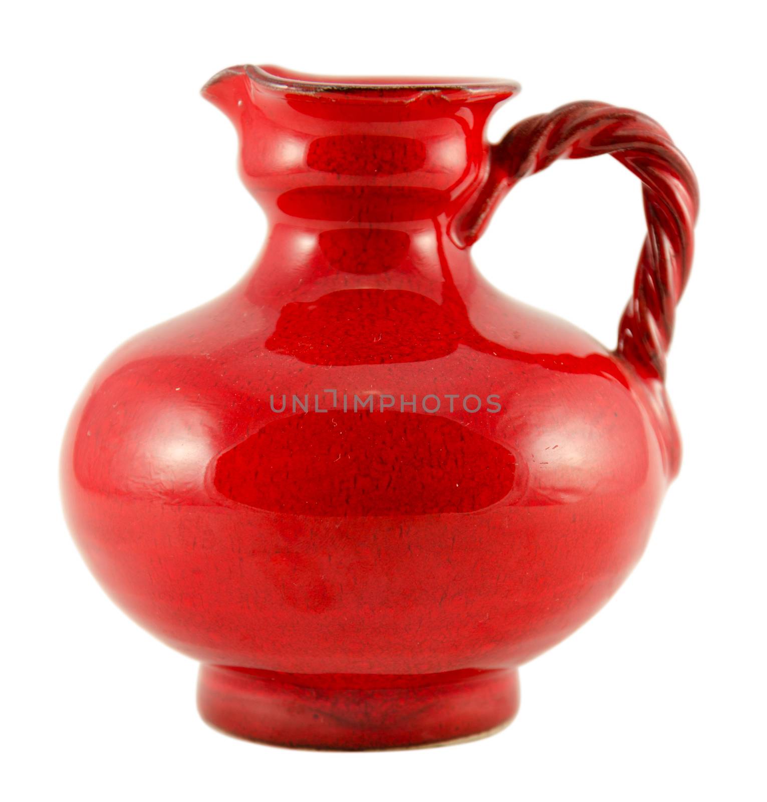 red ceramic old jug with handle isolated on white by sauletas